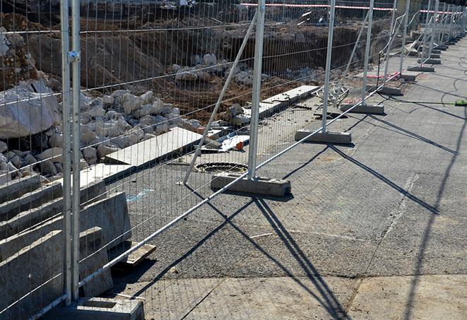 a temporary fence panel used for privacy and noise reduction at outdoor venues